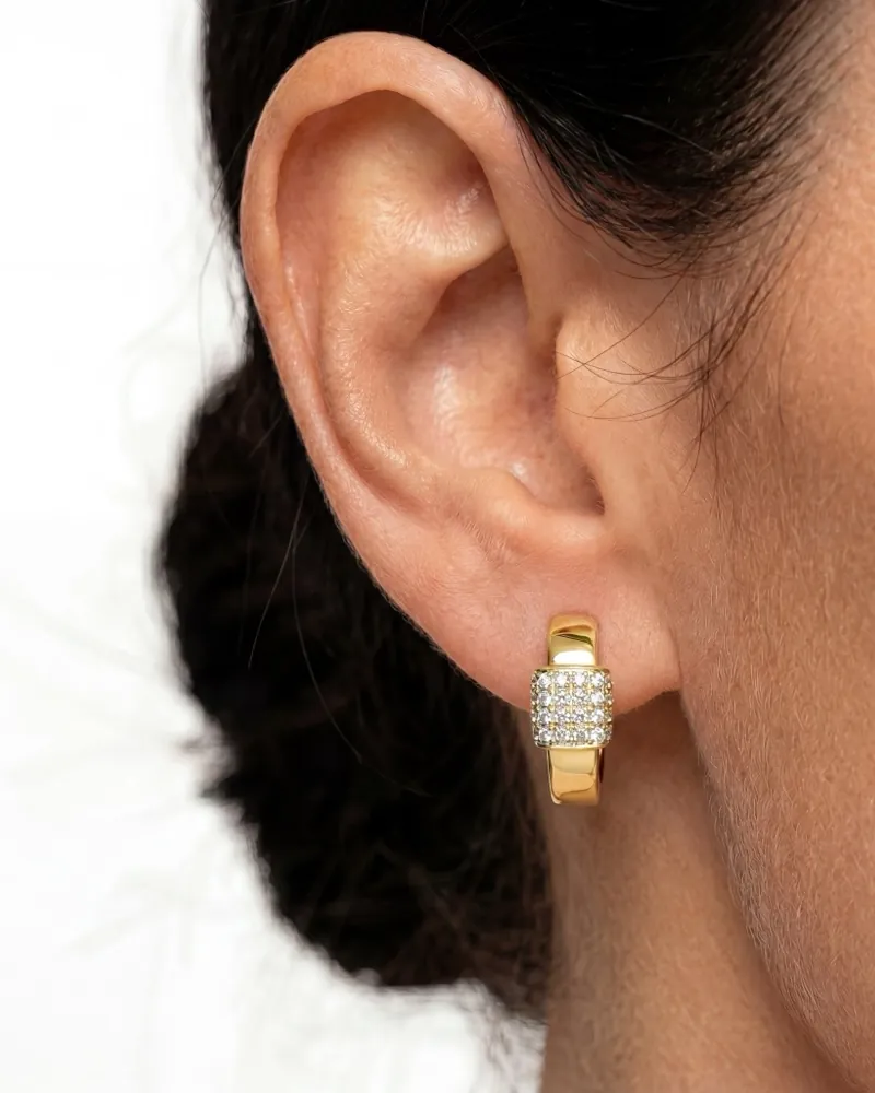 AI jewelry close-up: a gold pavé earring on an ear