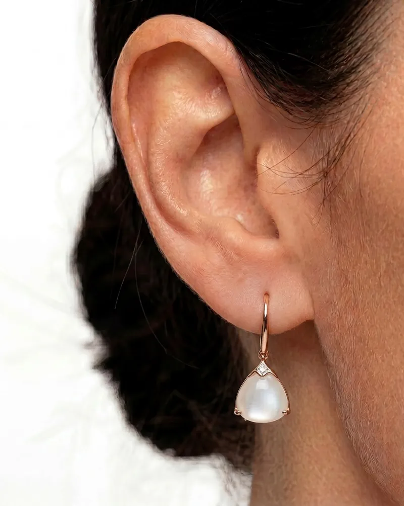AI jewelry close-up: a pearl-drop earring on an ear