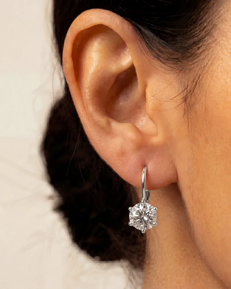 AI jewelry close-up: a silver solitaire earring on an ear
