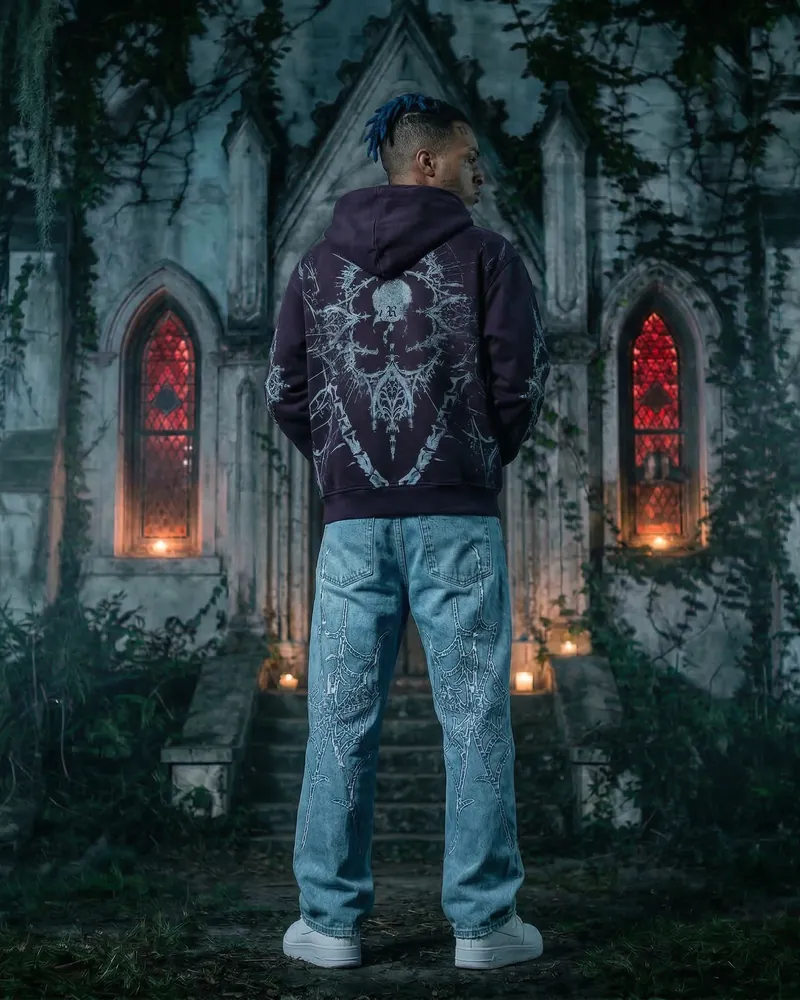 AI fashion photo: a model in a streetwear hoodie and jeans in front of a chapel with red windows, pose 5 of 6